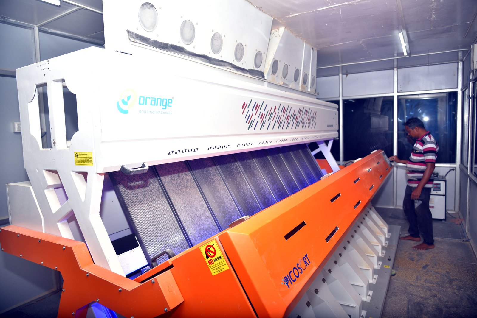 State-of-the-art rice sorting machine with worker